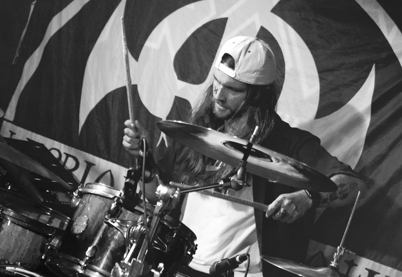 Cameron Jessop playing the drums, sticks in motion behind the cymbals